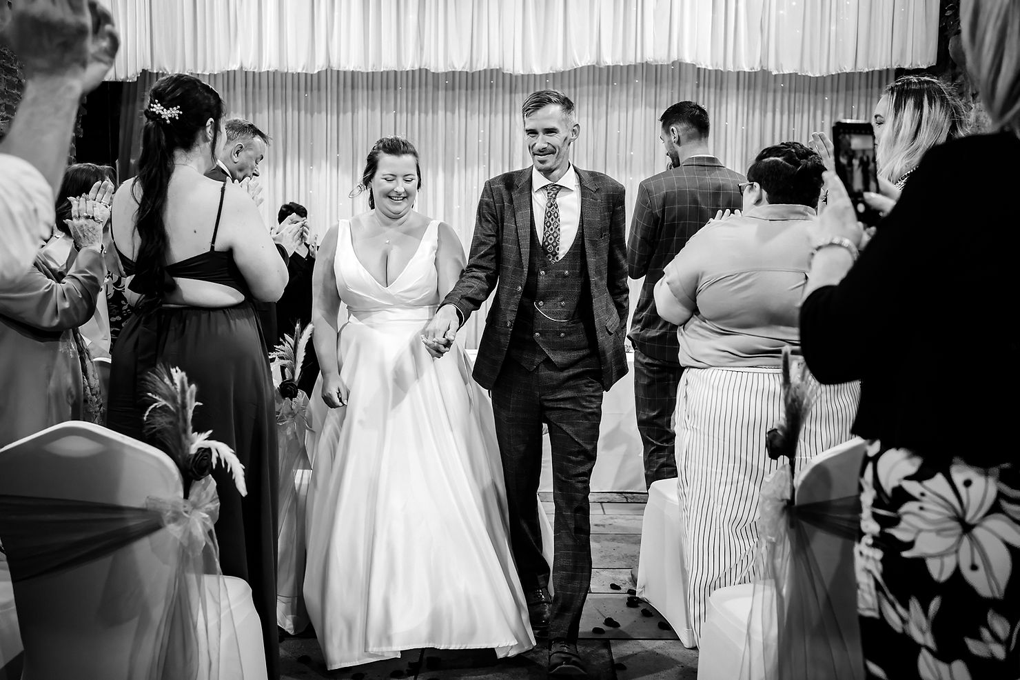 Bride and groom walking back down the aisle at The Square Tower in natural light, black and white