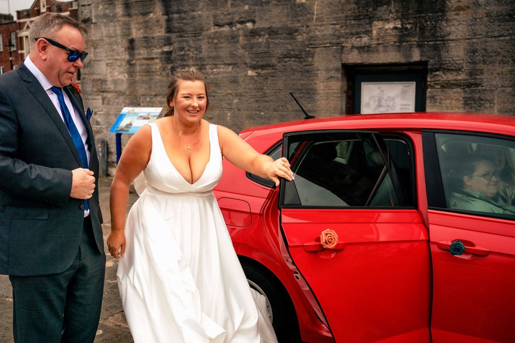 Bride arriving with her dad outside The Square Tower Old Portsmouth on an overcast day