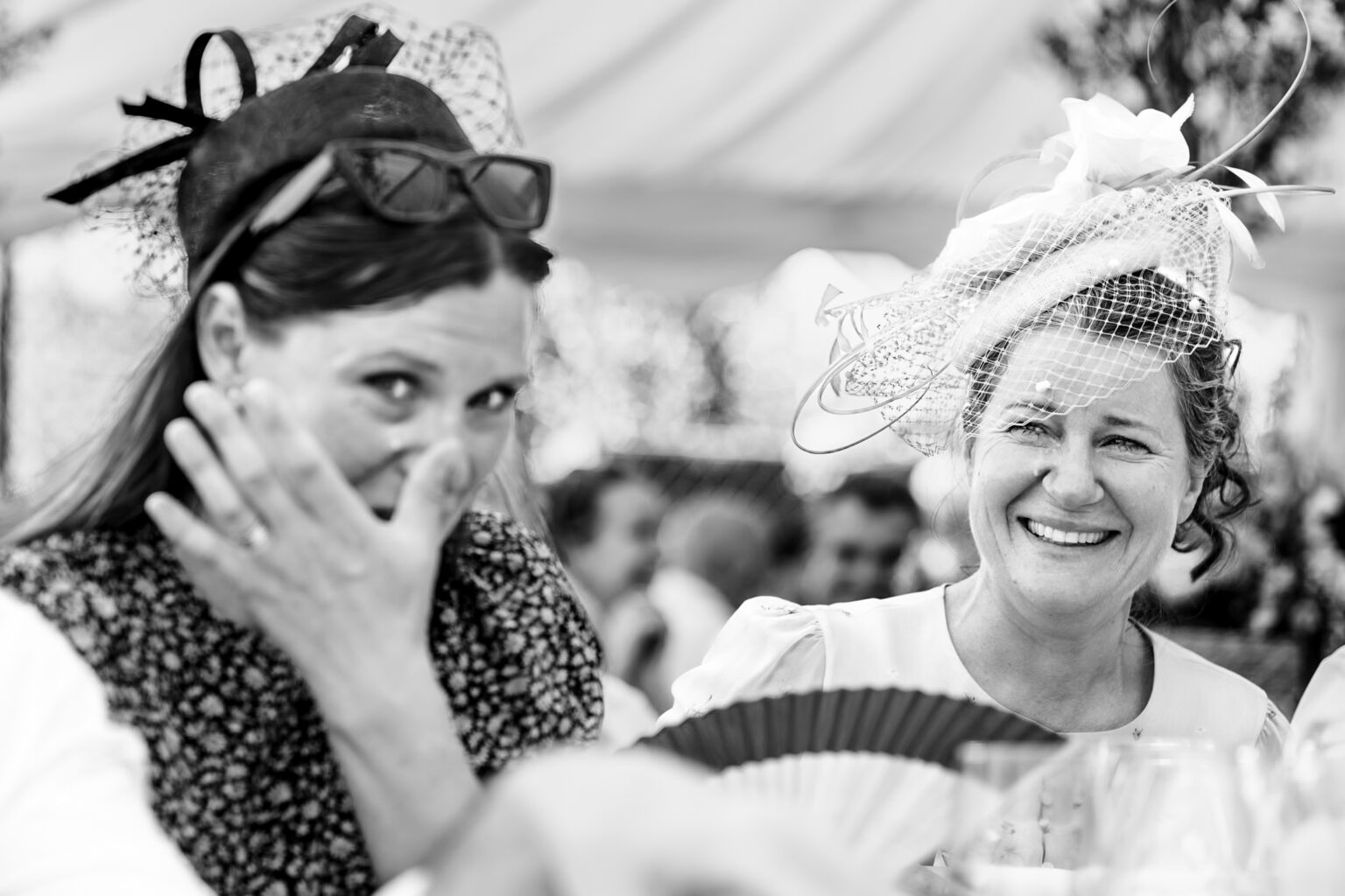 Guest wiping away happy tears during the speeches, black and white