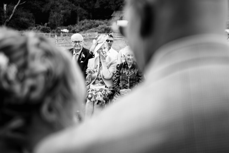 outdoor ceremony grooms mum wiping tear at Hampton Estate Surrey