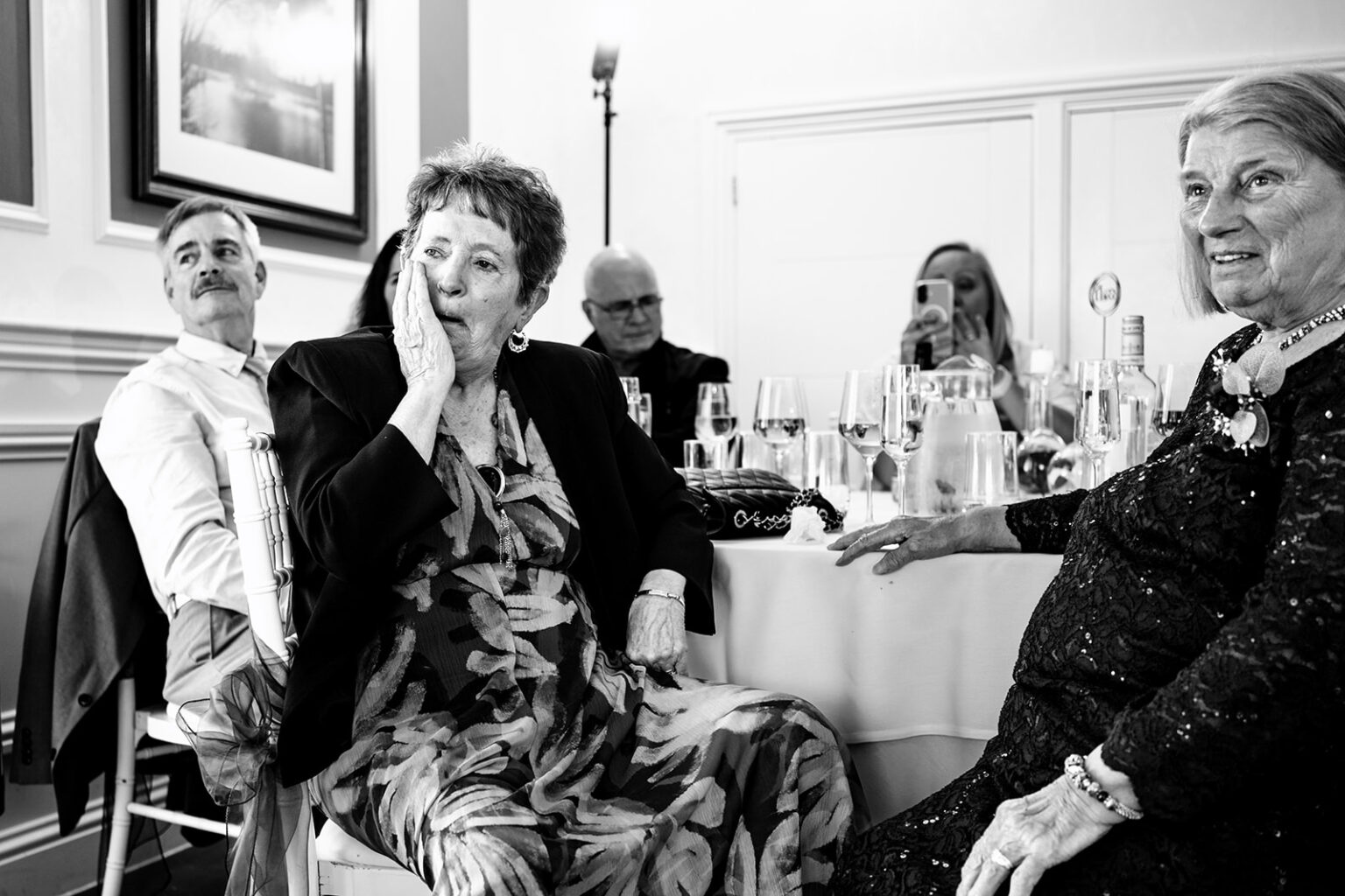 Guest howling with laughter during the speeches, black and white