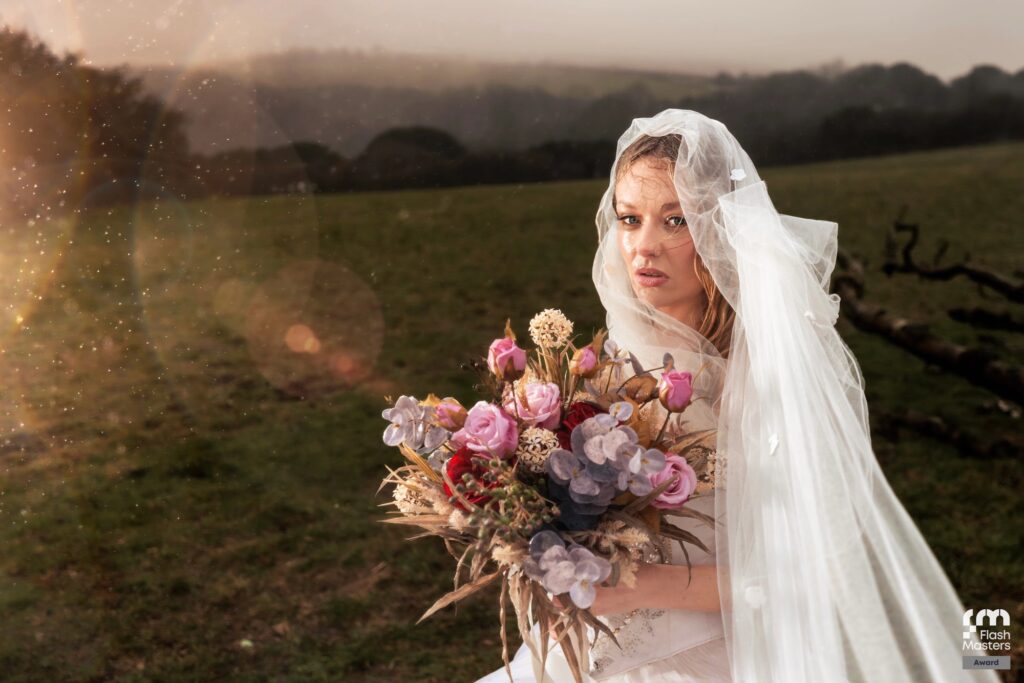 Creative veiled bride portrait holding bouquet at sunset, Flash Masters award winning