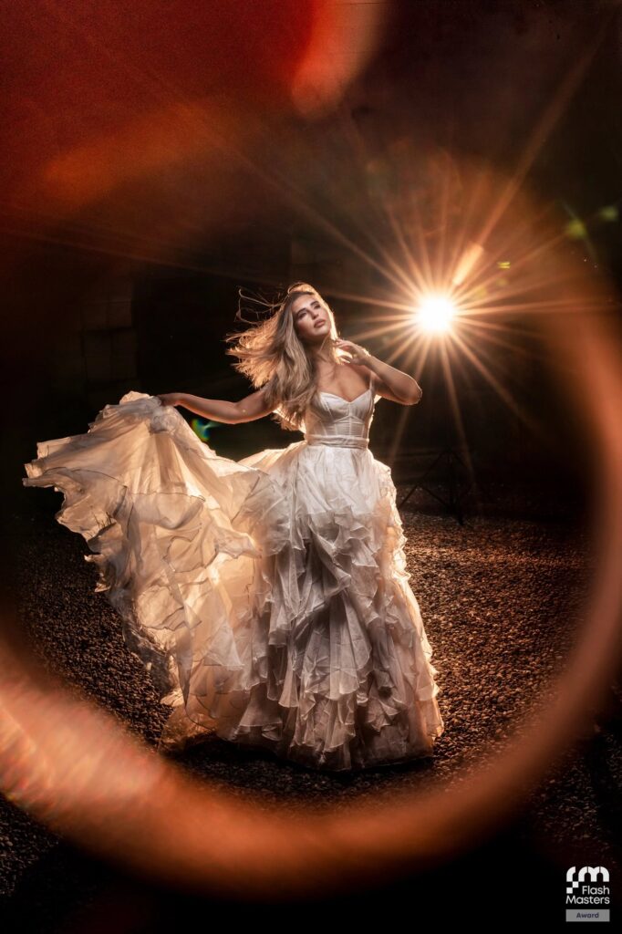 Bride in a flowing gown with sunburst backlight at night, Flash Masters award winning