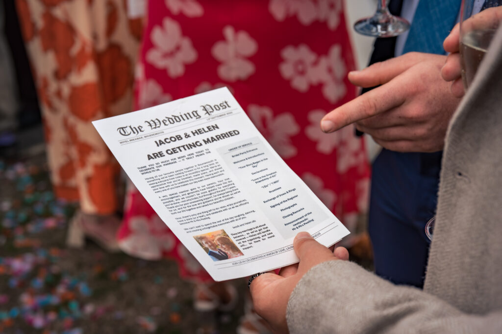 Guest holding a wedding newspaper order of the day at Hotel Miramar Bournemouth