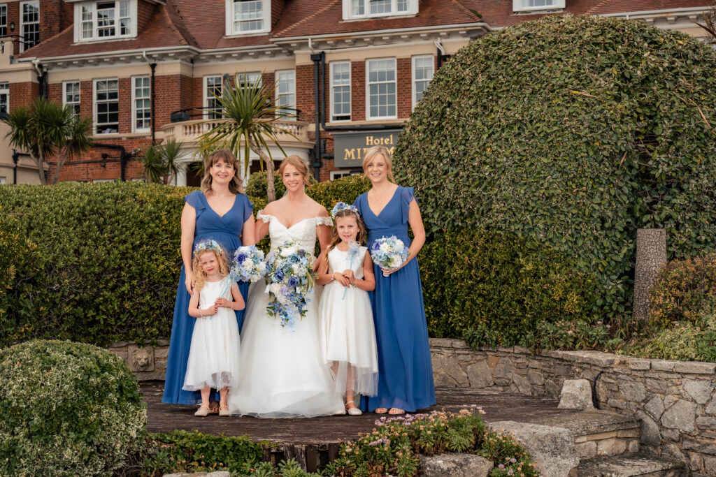 Bride with her bridesmaids and flower girls in front of Hotel Miramar