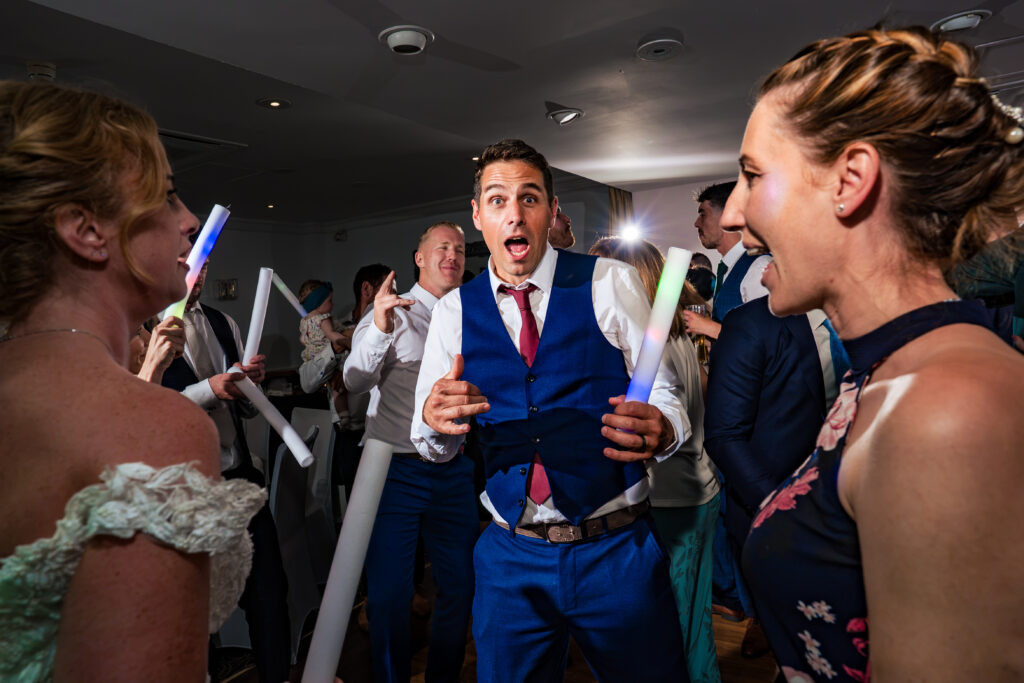 Groom and guests dancing with glow sticks at Hotel Miramar Bournemouth
