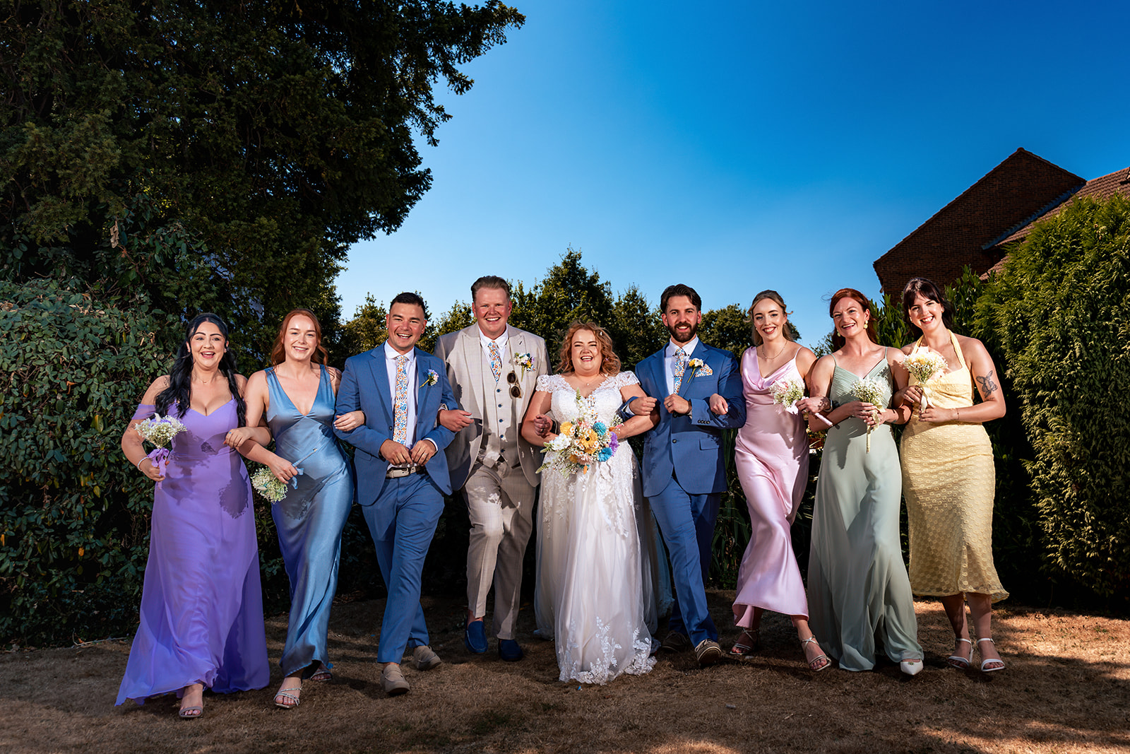 Colourful bridal party in the sunshine at Newtown House Hotel, Hayling Island