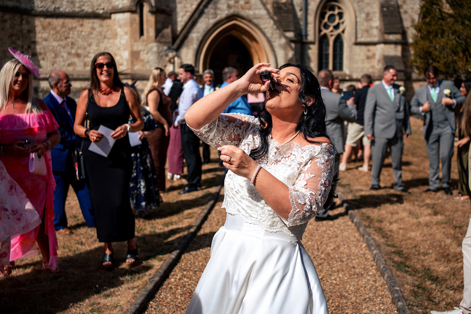 Bride celebrating outside St Matthew's Church, Blackmoor after the ceremony