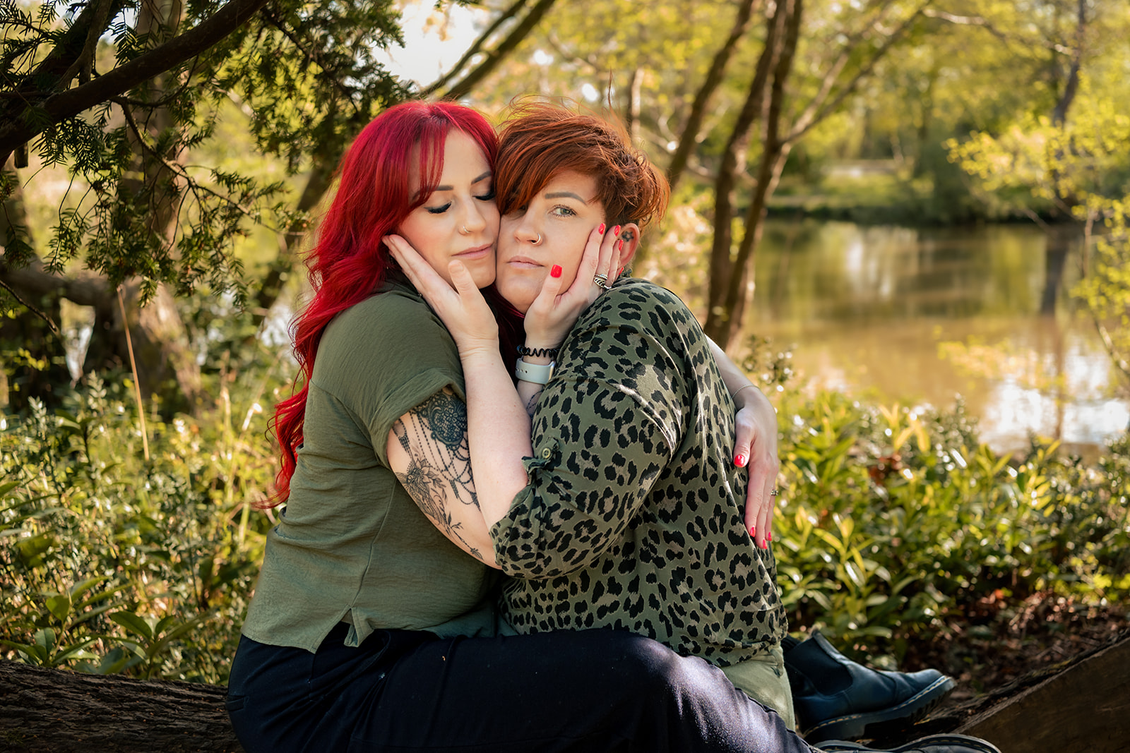 Affectionate couple by the lake at their 80s themed engagement shoot
