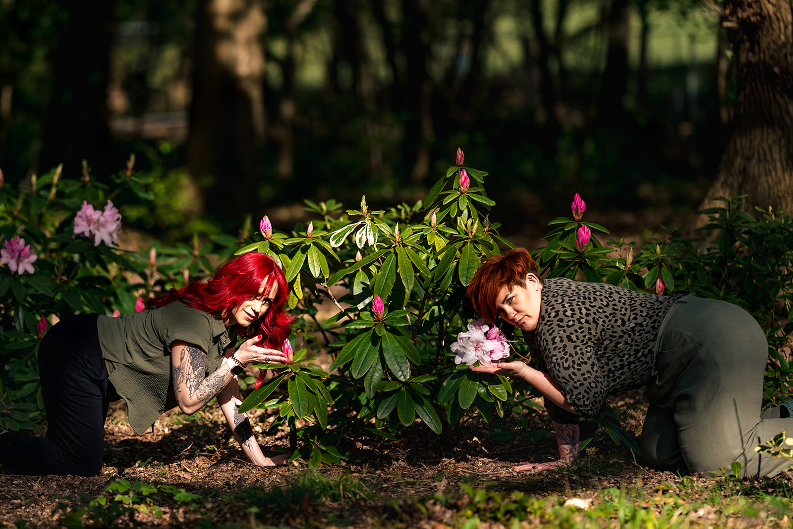 Couple peeking through spring flowers at an 80s themed engagement shoot