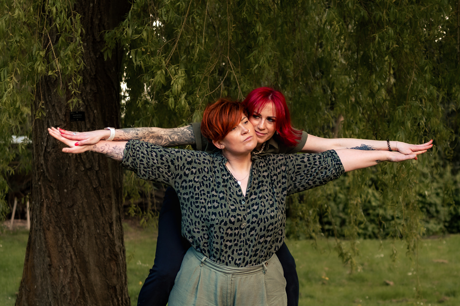 Fun 80s themed engagement shoot pose in the woodland