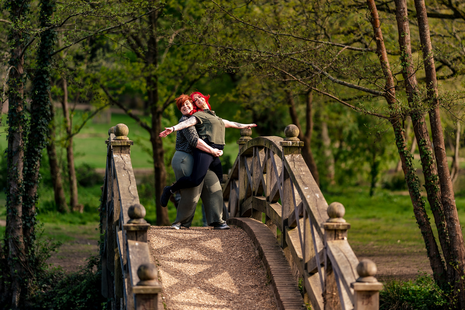 Same-sex couple on a wooden bridge at their 80s themed engagement shoot