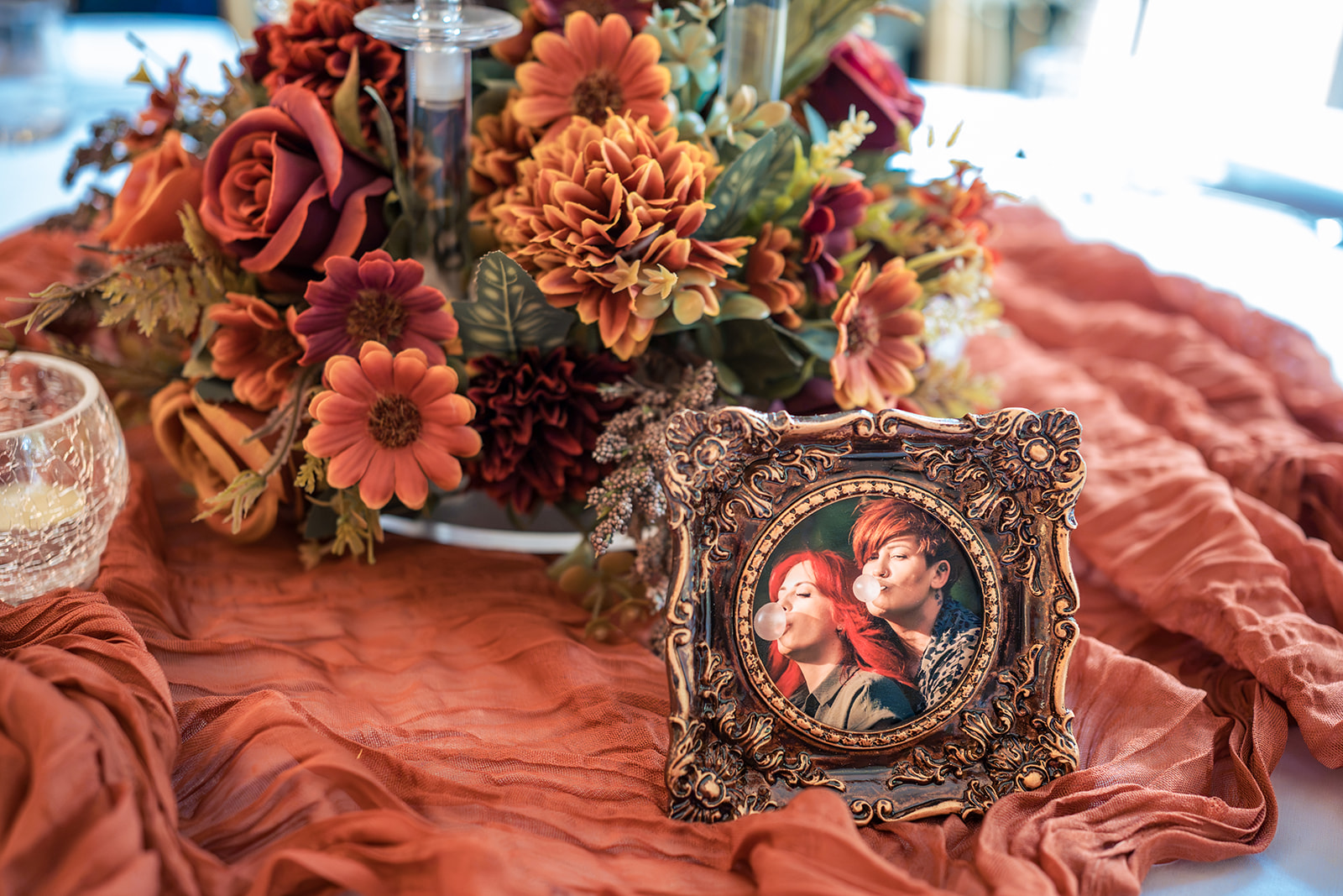 Framed engagement photos and flowers on display at a wedding at The Elephant at Pangbourne, Berkshire