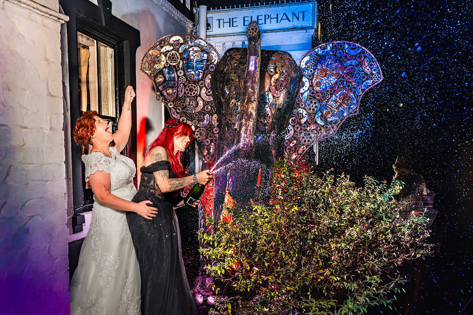 Champagne spray beside the elephant with coloured flash at The Elephant at Pangbourne, Berkshire