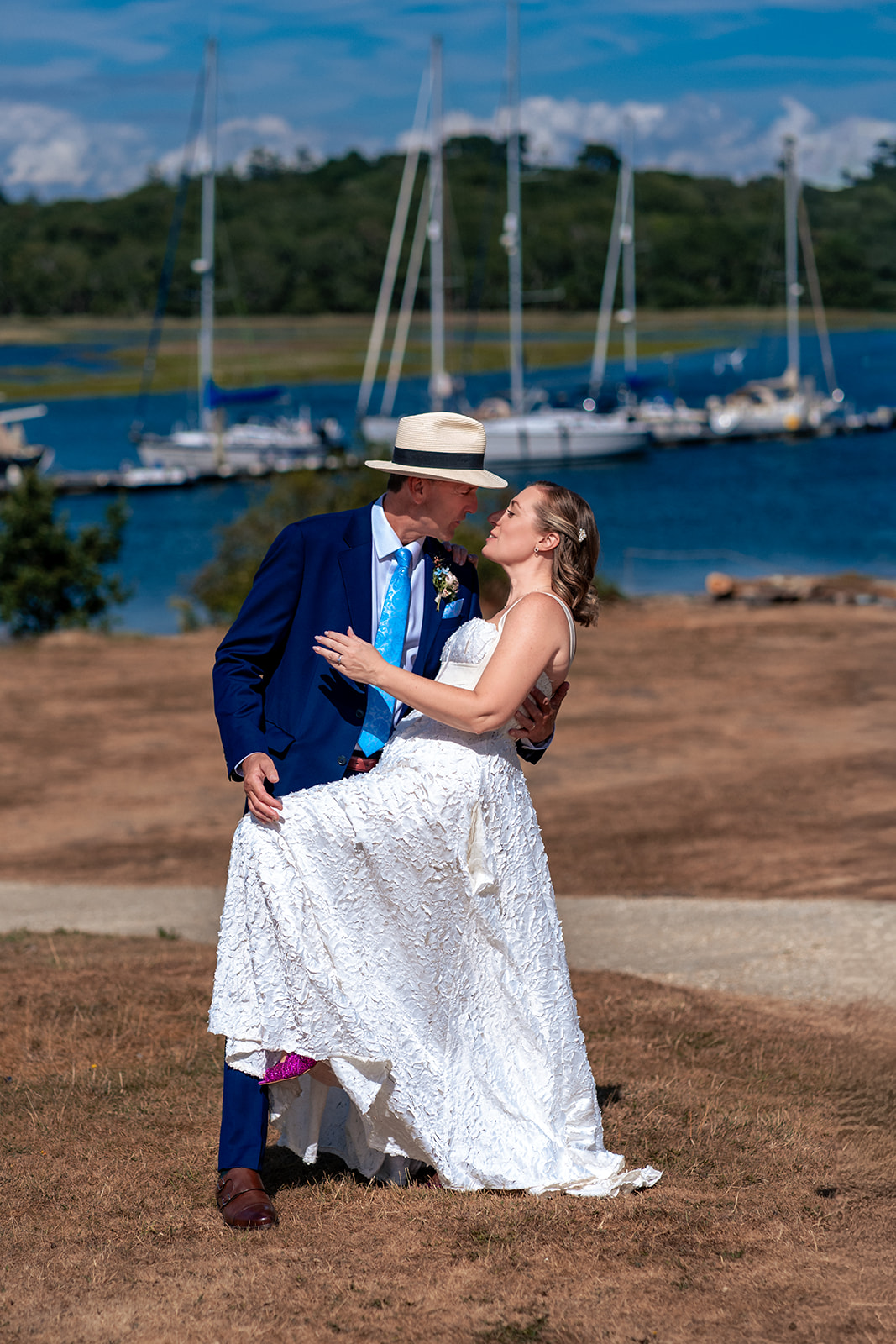 Bride and groom by the water at Buckler's Hard on the Beaulieu River