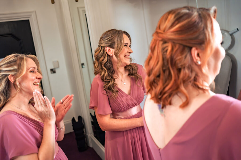 Bridesmaids laughing together during bridal prep at The Queens Hotel