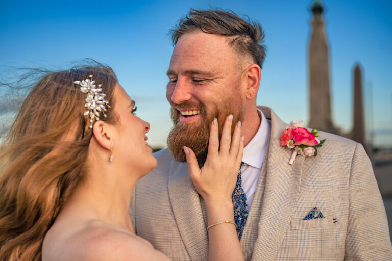 Bride and groom golden hour portrait by the war memorial on Southsea seafront