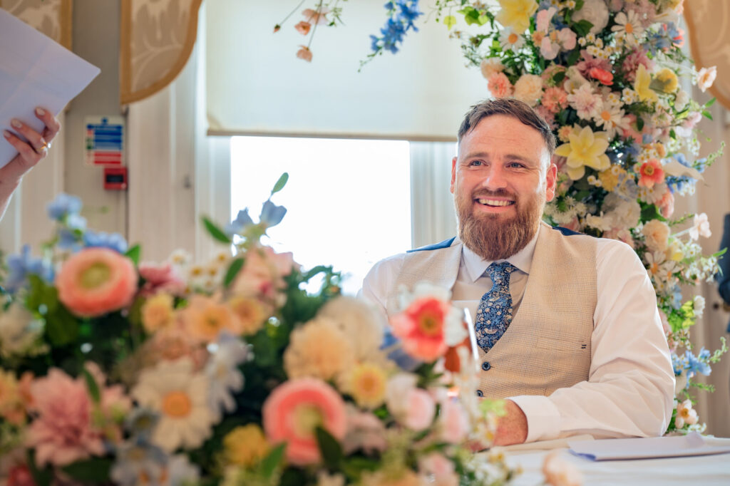 Groom laughing during the wedding speeches at The Queens Hotel Southsea
