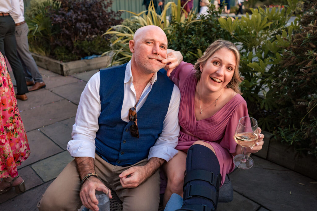Two wedding guests laughing together at The Queens Hotel Southsea