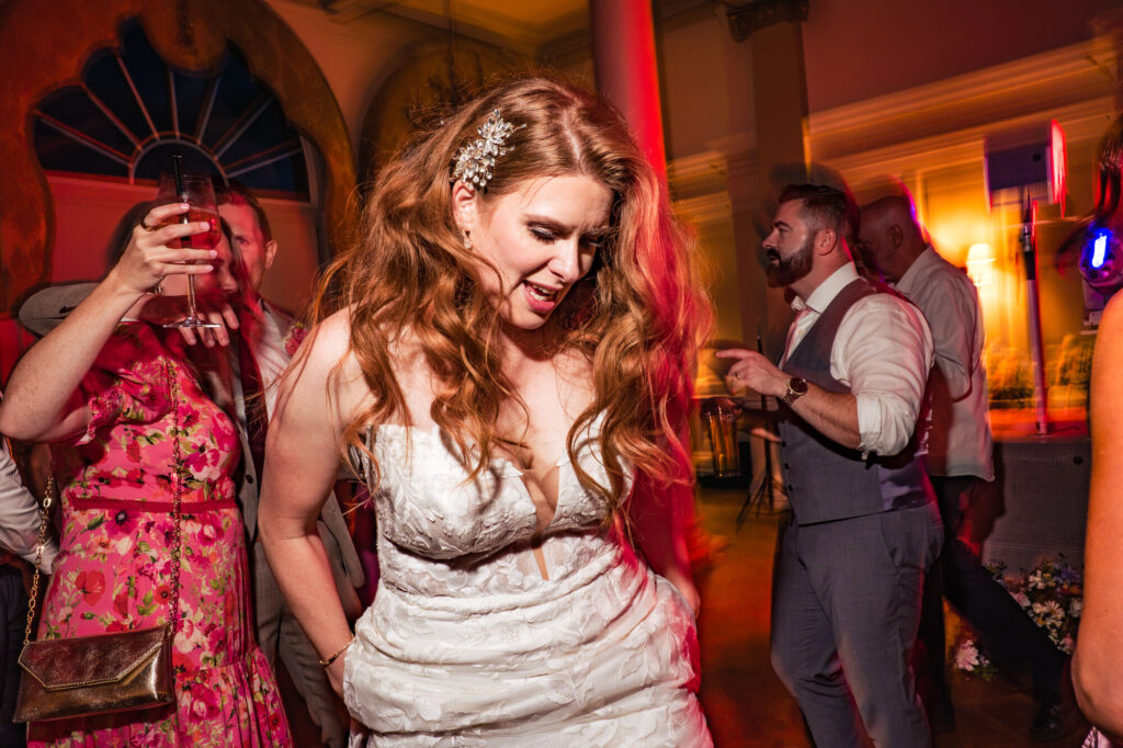 Bride dancing under colourful lights at The Queens Hotel Southsea