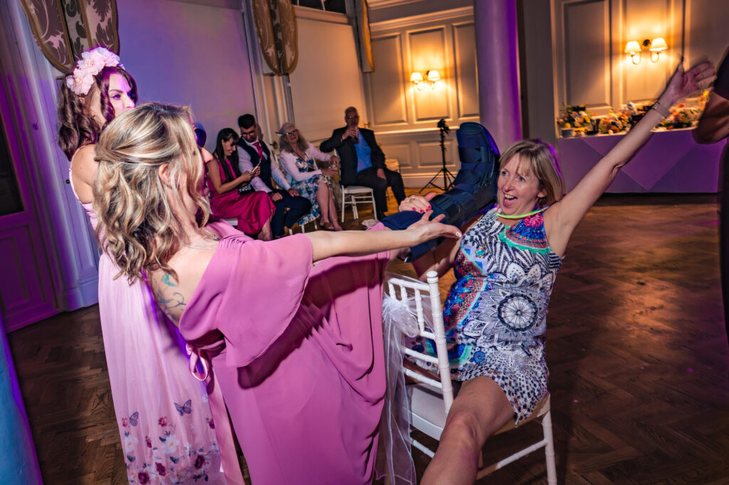 Wedding guests playing a chair game at the evening reception at The Queens Hotel