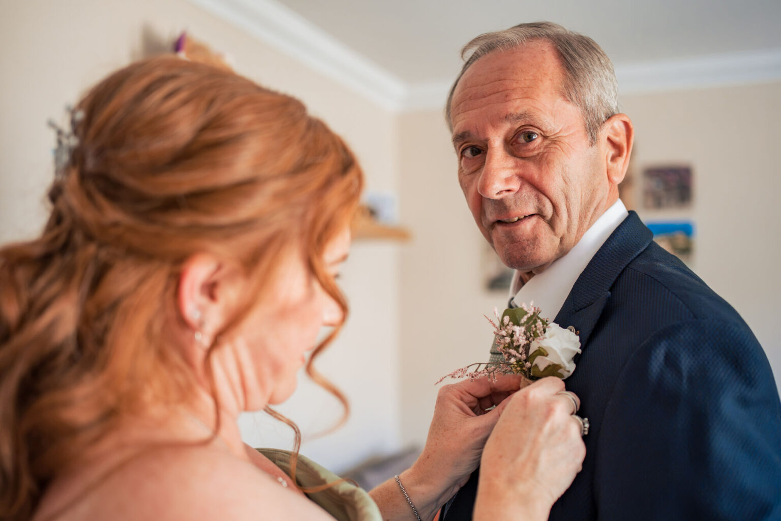Bride pinning her dad's buttonhole before her Square Tower Old Portsmouth wedding