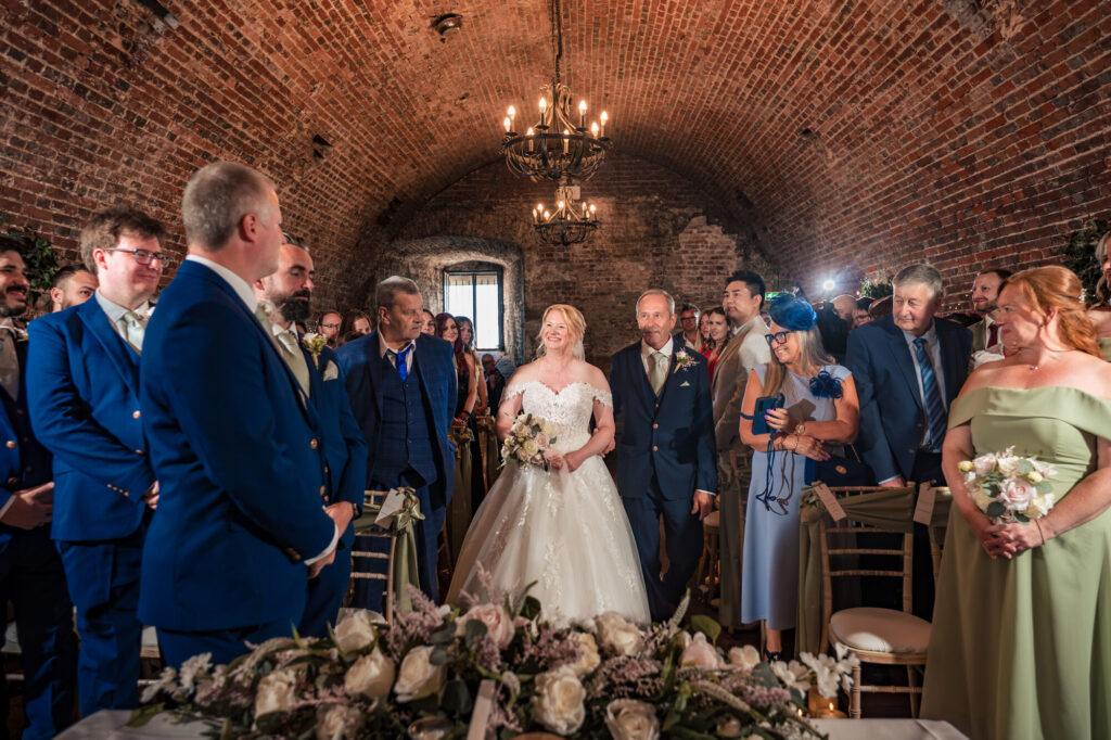 Bride walking down the aisle with her father at The Square Tower Old Portsmouth