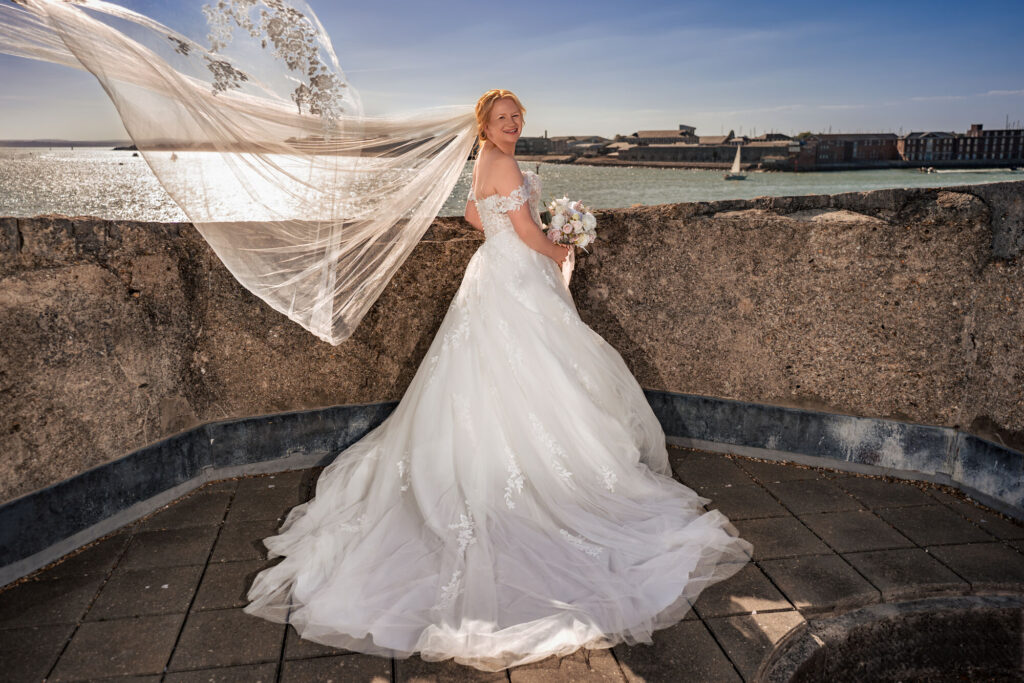 Bride with her veil flowing in the wind on the rooftop at The Square Tower Old Portsmouth