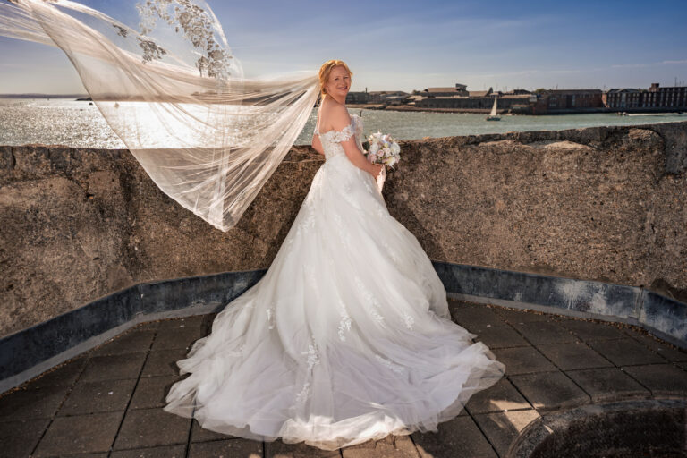 Bride's veil blowing in the wind on the rooftop of The Square Tower, Old Portsmouth