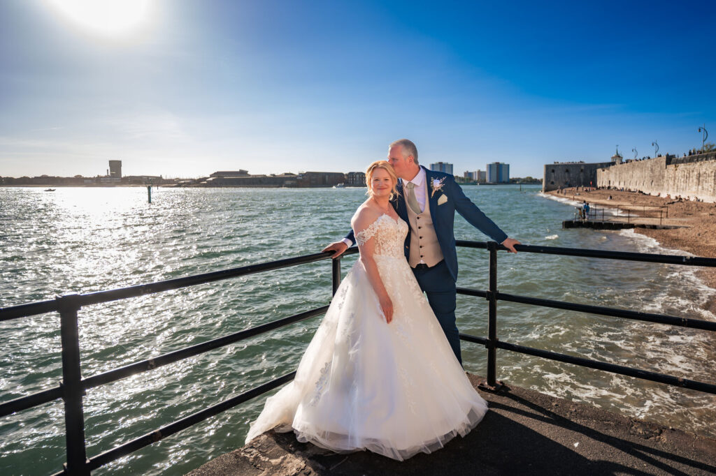 Relaxed bride and groom portrait by the water in Old Portsmouth