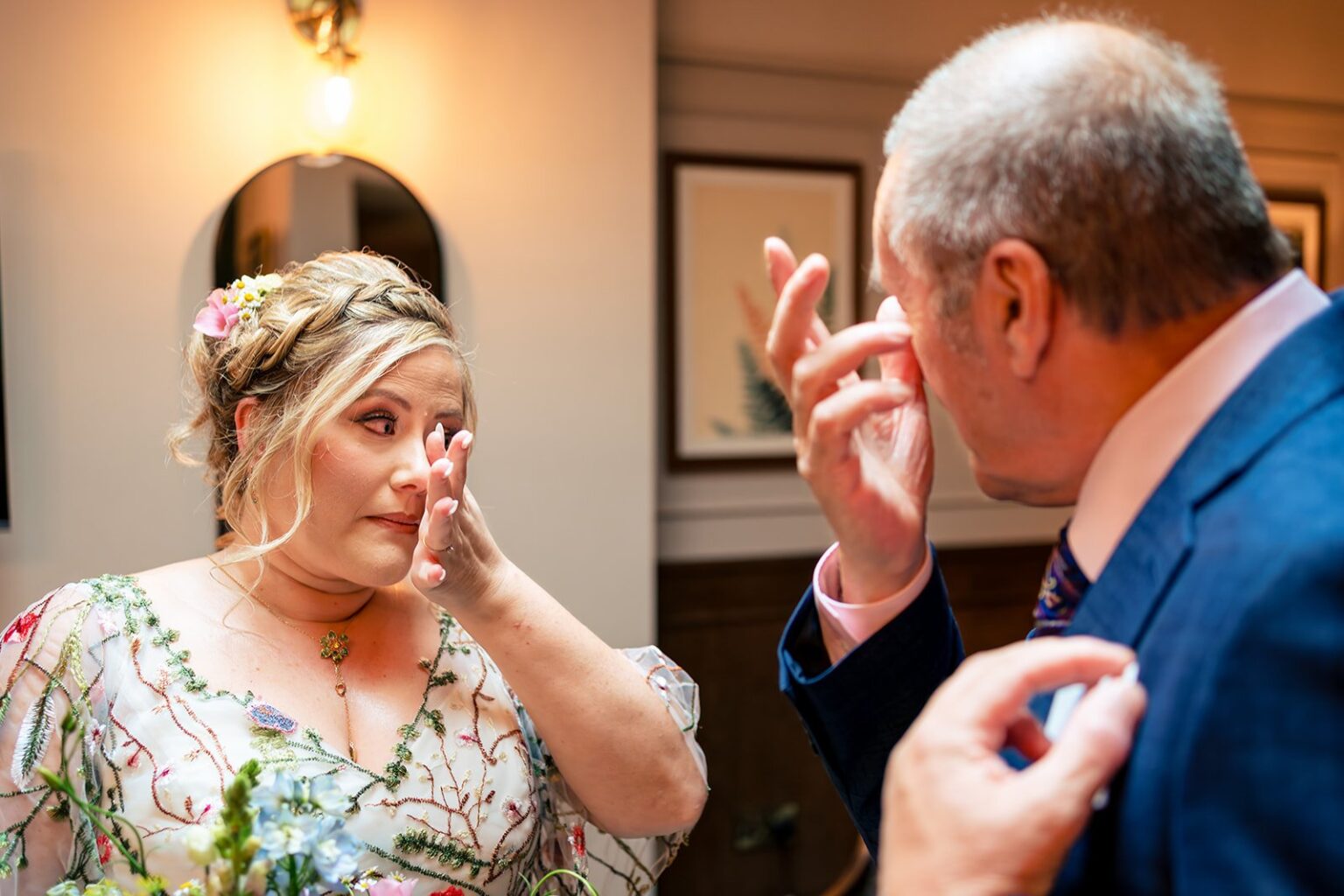 Bride and her dad wiping away tears before the ceremony at Hampton Estate, Surrey