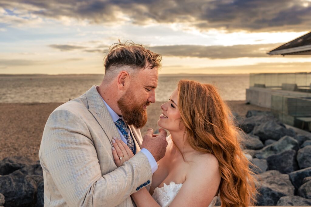 Bride and groom at golden hour on the beach near The Queens Hotel Southsea