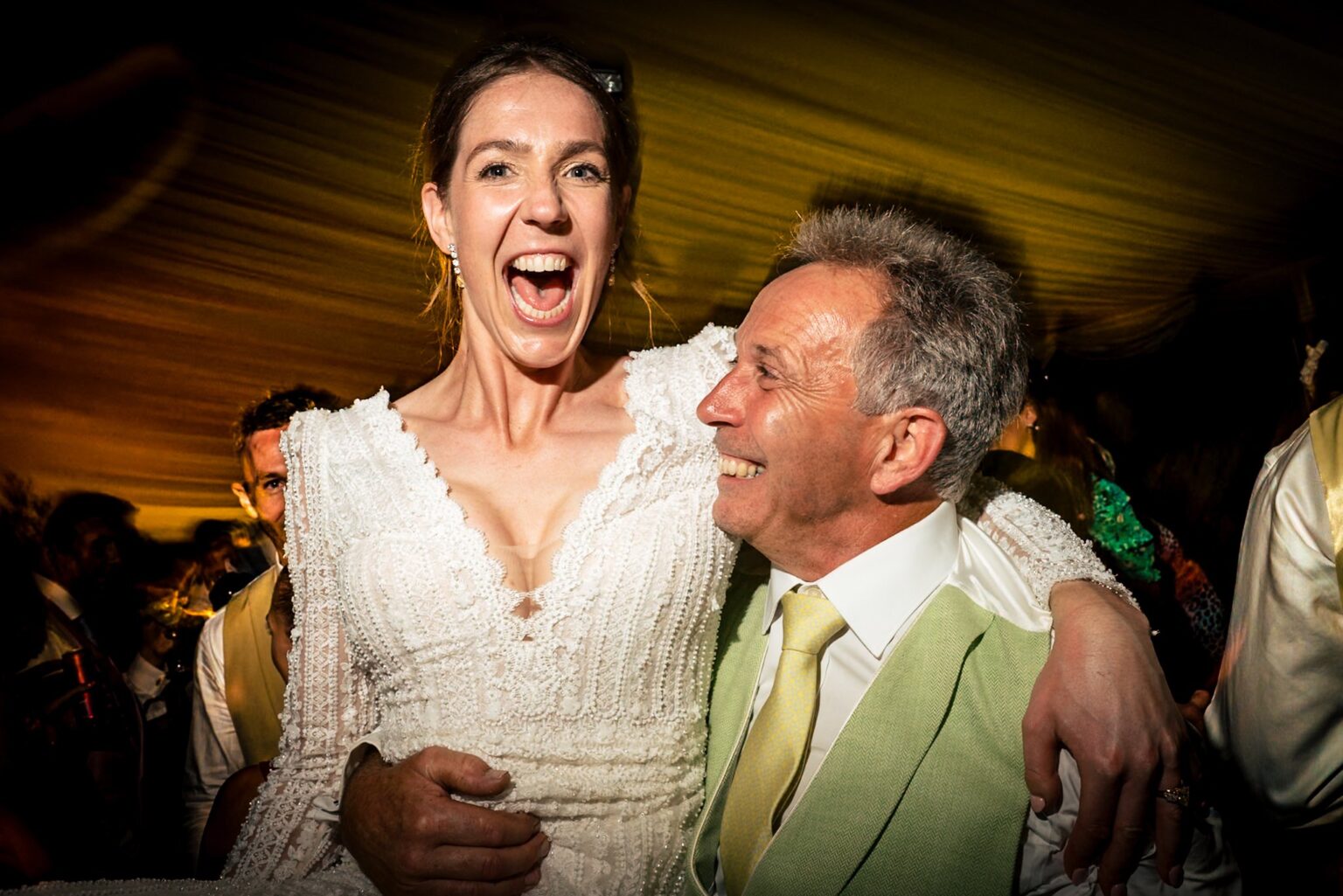 Bride screaming with joy on the dancefloor with her dad