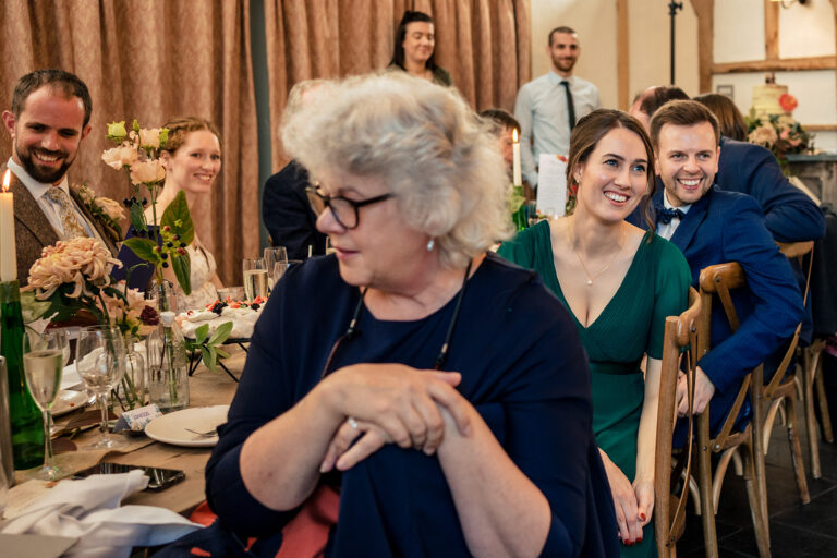 Older guest laughing during the speeches at Kimbridge Barn, Test Valley, Hampshire