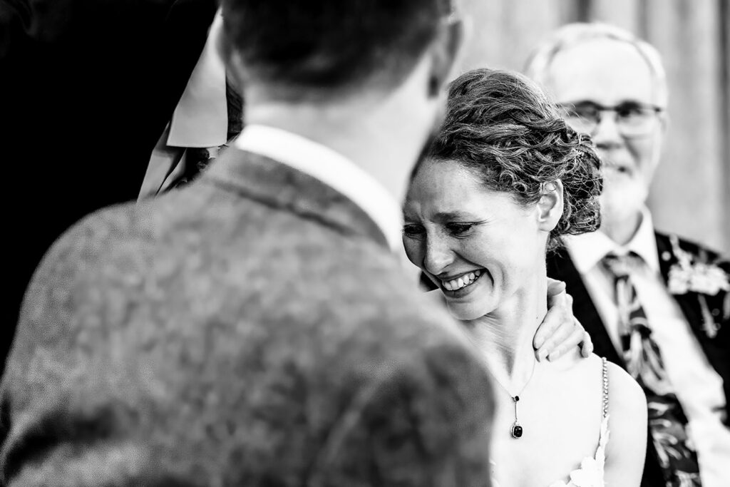 Bride and groom during the speeches, black and white, at Kimbridge Barn, Test Valley, Hampshire