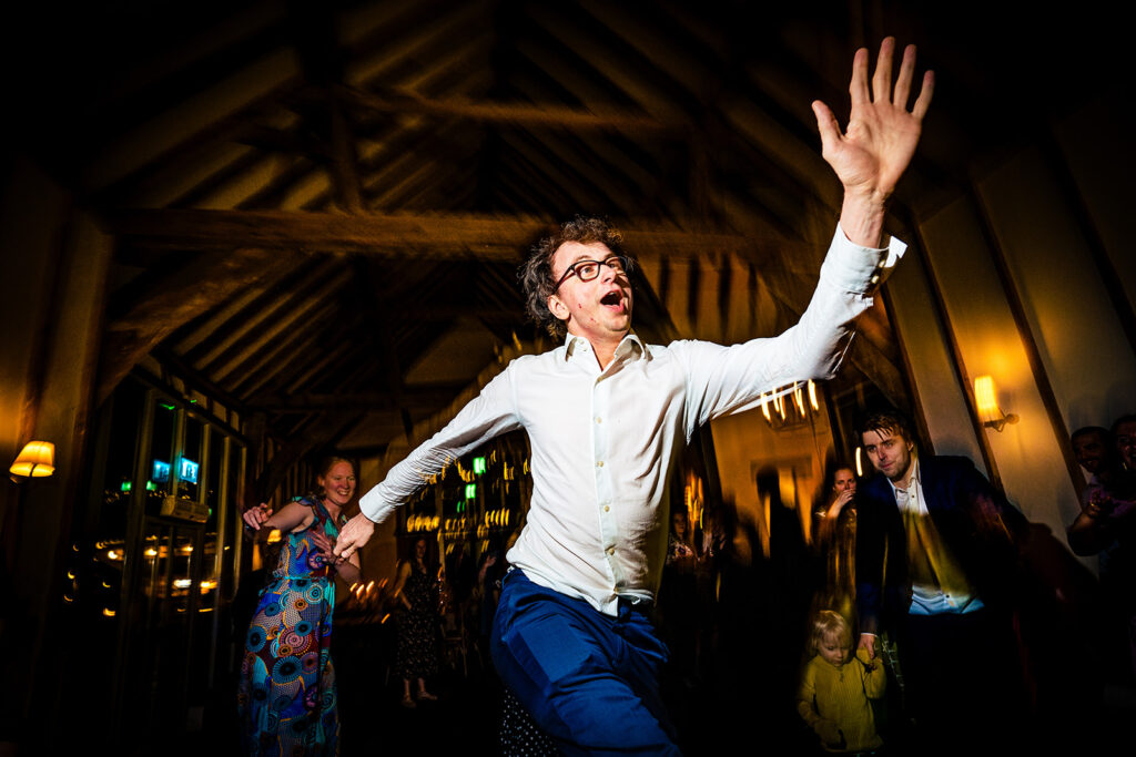 Guest dancing wildly on the dancefloor at Kimbridge Barn, Test Valley, Hampshire