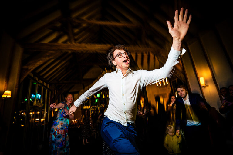 Guest dancing wildly on the dancefloor at Kimbridge Barn, Test Valley, Hampshire