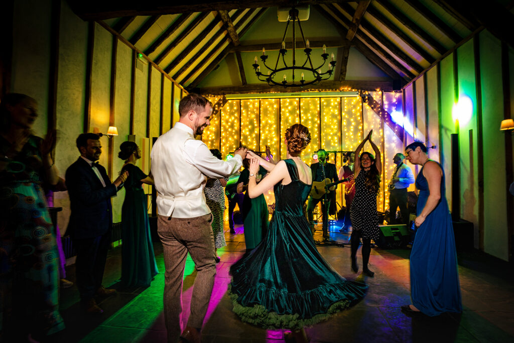 Packed dancefloor with colourful lights in the barn at Kimbridge Barn, Test Valley, Hampshire