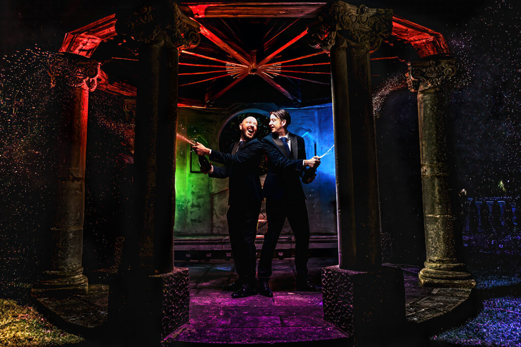 Two grooms in a colourful flash lit portrait at night, Chichester