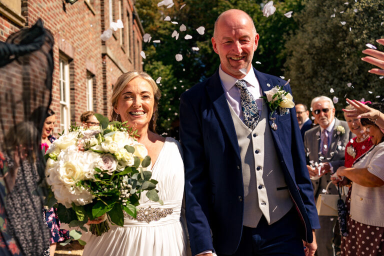 Bride and groom with flowers outside at Portsmouth Register Office, Hampshire