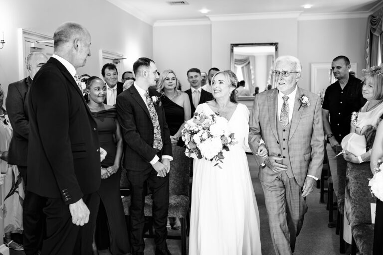 Wedding guests in the ceremony room, black and white, at Portsmouth Register Office, Hampshire