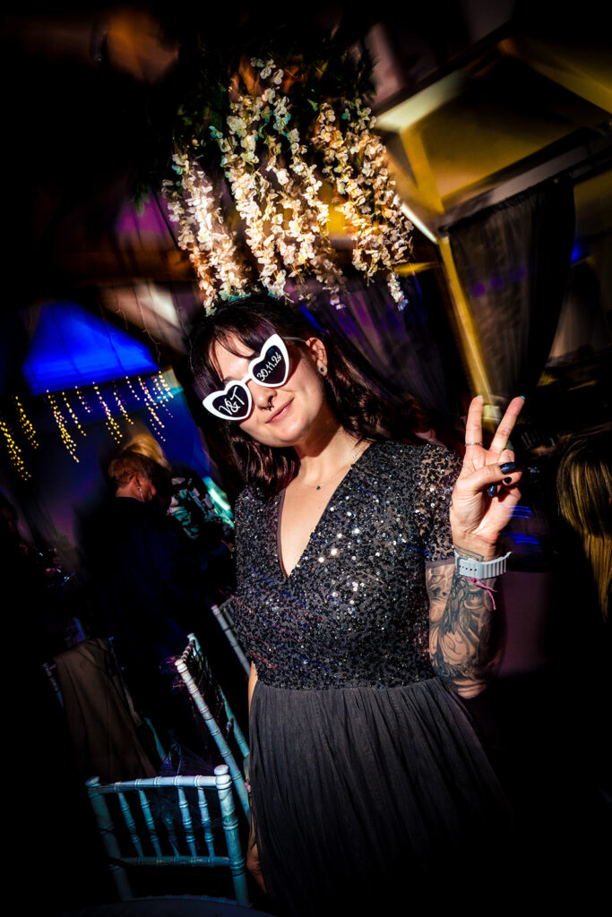 Guest dancing in sunglasses under colourful lights at Newtown House Hotel, Hayling Island