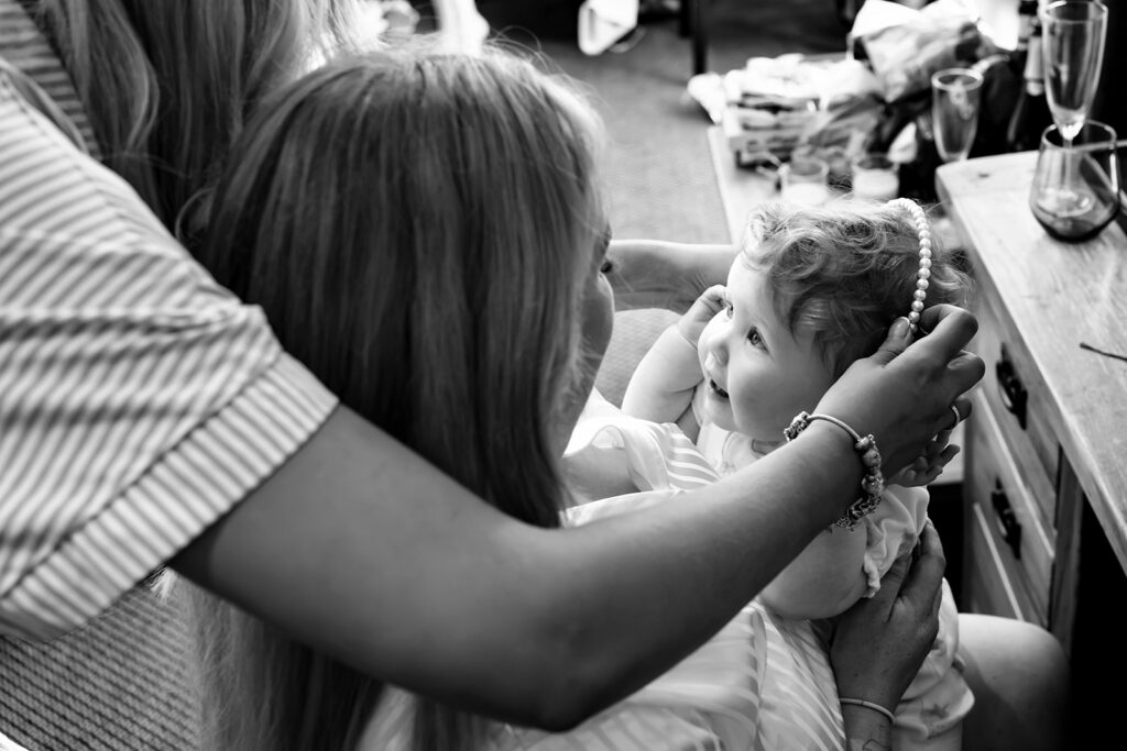 Flower girl getting ready during bridal prep at Newtown House Hotel, black and white