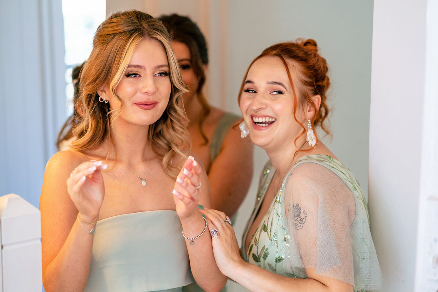 Bridesmaids clapping and cheering as they see the bride