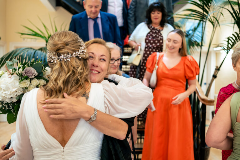 Bride hugging a guest after the ceremony at Portsmouth Register Office, Hampshire