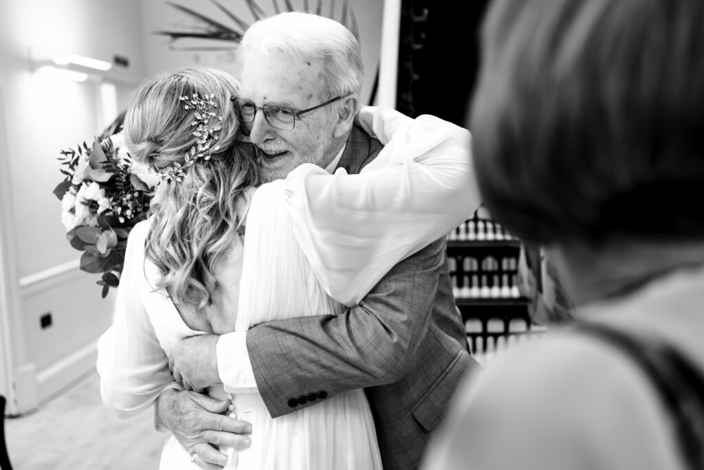 Bride and groom hugging, black and white, at Portsmouth Register Office, Hampshire
