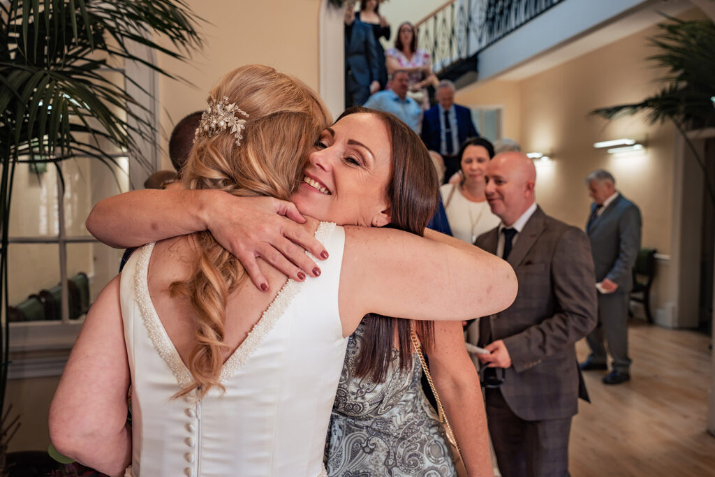 Bride hugging a guest after the ceremony at Portsmouth Register Office, Hampshire