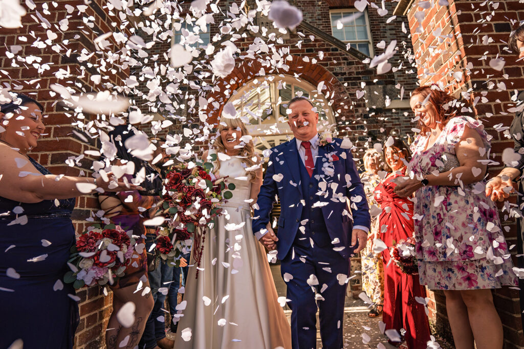 Bride and groom walking through confetti at Portsmouth Register Office, Hampshire