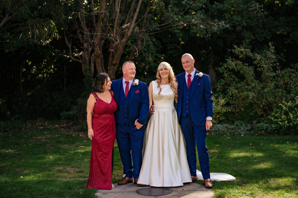 Bride and groom with bridesmaids in the gardens at Portsmouth Register Office, Hampshire