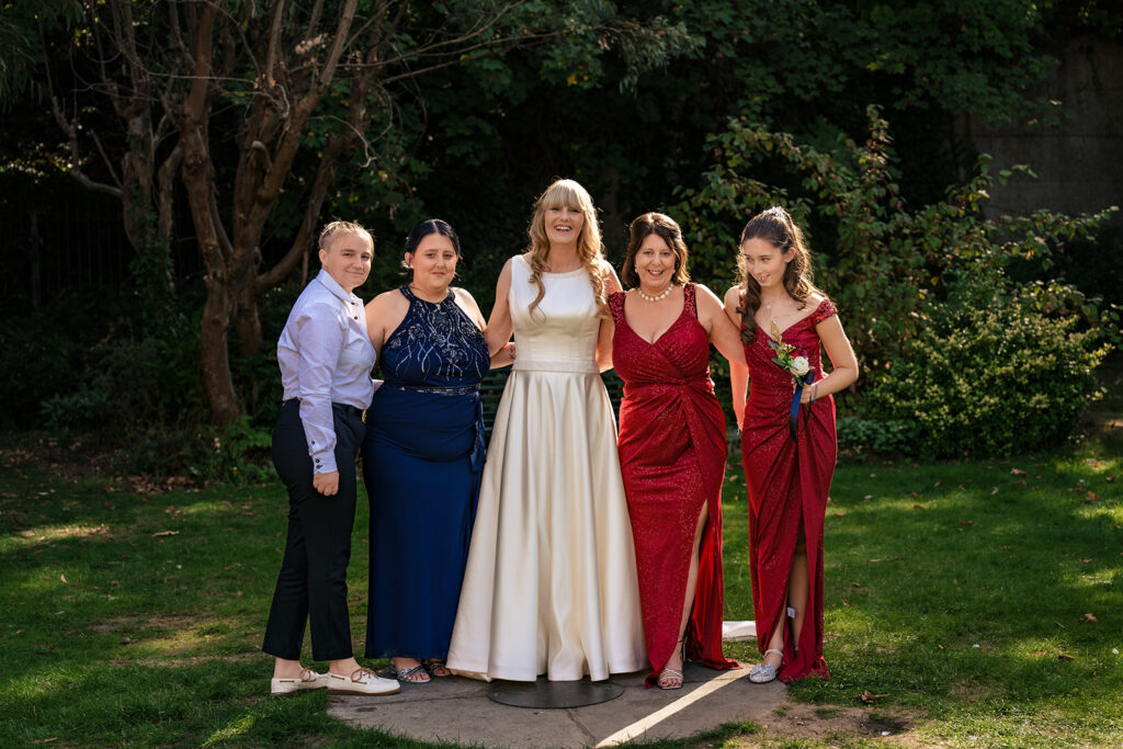 Bride with her bridesmaids in the gardens at Portsmouth Register Office, Hampshire
